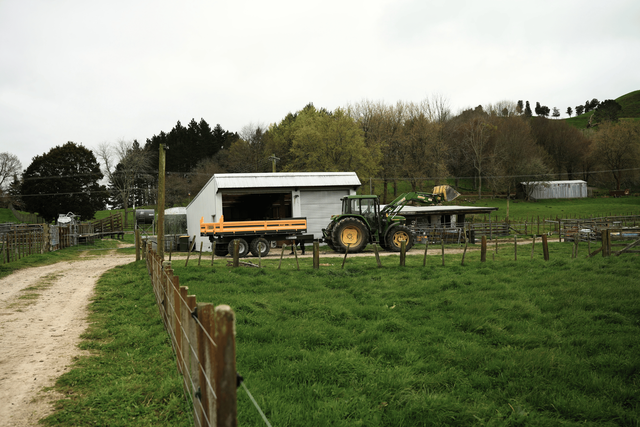 Tractor and Maxi tip trailer parked back at the farm shed
